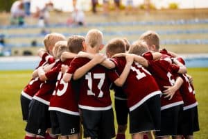 Sports team huddling